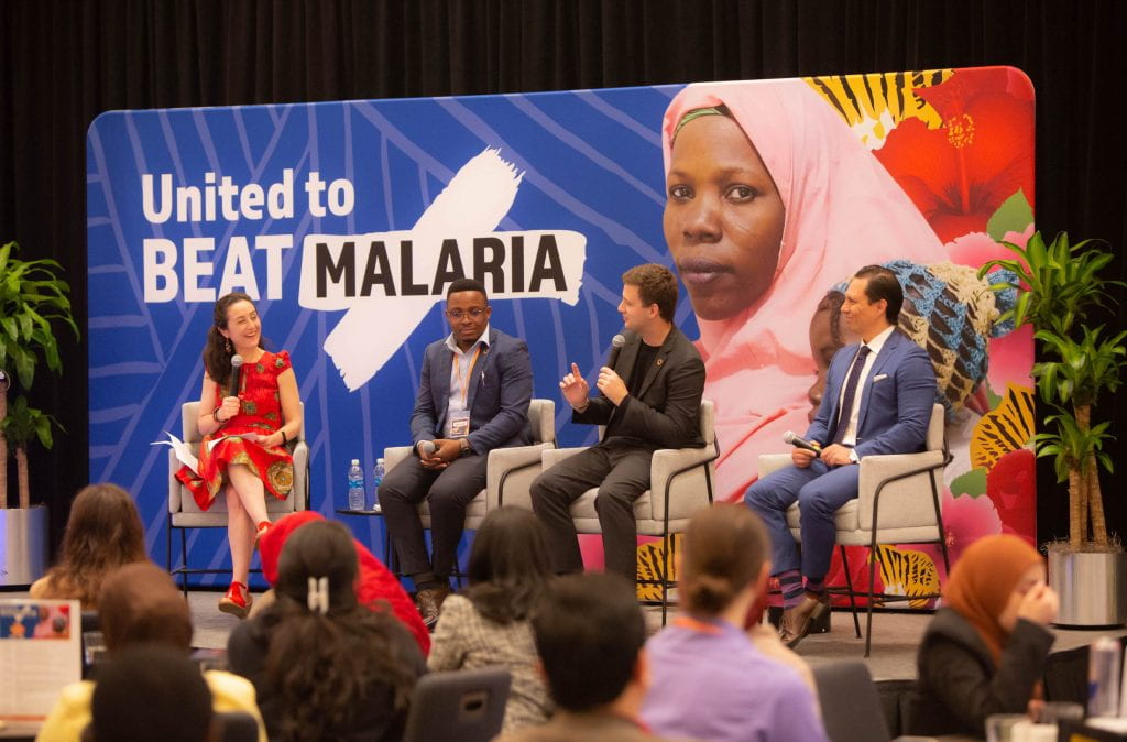 Margaret McDonnell (Executive Director of United to Beat Malaria), Aloyce Urassa, Adriano de Bernardi Schneider, and Luis Miguel Perez speaking on a panel at the 2023 United to Beat Malaria Leadership Summit. Photo by United to Beat Malaria, United Nations Foundation.