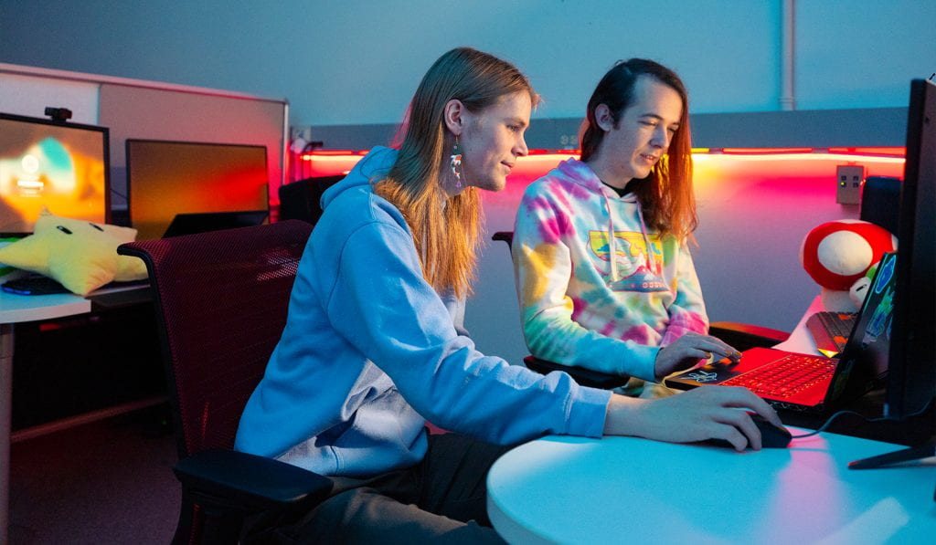 Two students work on game design